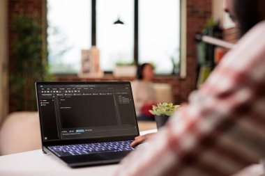 Male IT engineer programming app code, developing online software with cloud server and firewall security. Coding new user interface with binary code html program, web development.