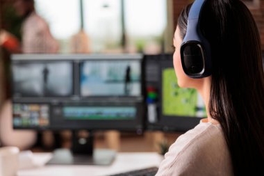 Creative videographer editing movie footage at home, using professional effects software. Content creator working on multimedia montage with app and audio, post production film.