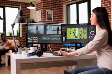 Content creator working with video editing software to create professional montage with audio and visual effects. Videographer using post production footage to edit film or movie.