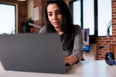 Freelancer doing remote online job at home, using laptop to send email and analyze research information. Working on internet report with startup network or attending school class lesson.