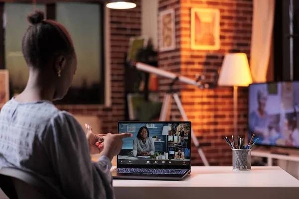 Woman attending online job interview, speaking with HR manager on videocall using laptop, back view. Teleconference with coworkers, remote team brainstorming on business meeting