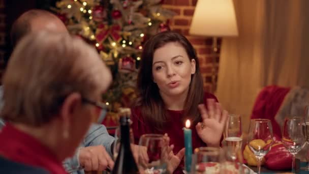 Beautiful Wife Chatting Senior Woman While Enjoying Christmas Dinner Home — стоковое видео
