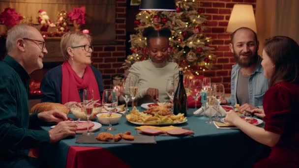 Весела Різноманітна Сім Насолоджується Різдвяною Вечерею Всередині Затишної Квартири Прикрашеної — стокове відео