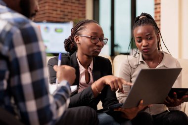 Coworkers team analyzing data on papers and laptop to plan online presentation with research information, sending email to manager. Doing teamwork collaboration to create company report files.