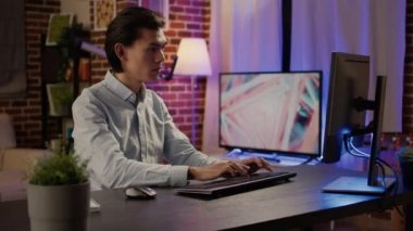 Company employee working on successful business report, creating commercial presentation with online website app. Writing email to executive manager and doing paperwork. Handheld shot.