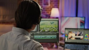 Media colorist editing video montage on visual effects software, using color grading for film and sound in post production house. Movie footage edit with artistic tools. Handheld shot.