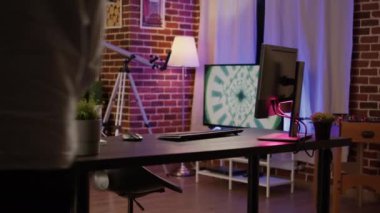 Asian male freelancer working on startup business using computer at desk, writing data report on website network. Doing executive and commercial paperwork on pc browser. Handheld shot.