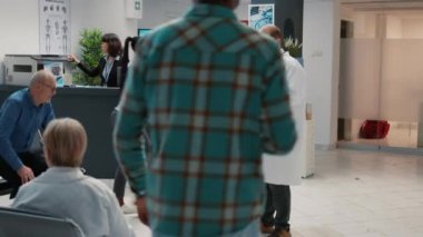 Asian patient chatting with physician about diagnosis on digital tablet, explaining disease to give support and assistance in hospital reception. Examination appointment and checkup visit.