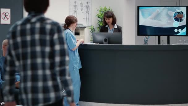 Busy Reception Desk Many Patients Waiting Attend Consultation Trying Write — Stockvideo