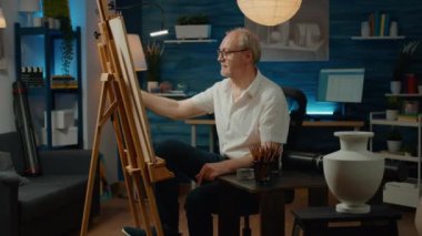 Portrait of retired man drawing professional artwork on canvas, using creative skills to sketch authentic vase model at home. Artistic tools and equipment to draw masterpiece with creativity.