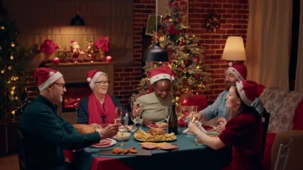 Happy Family Wearing Festive Hats Gathered Home Sitting Christmas Dinner — Stockvideo