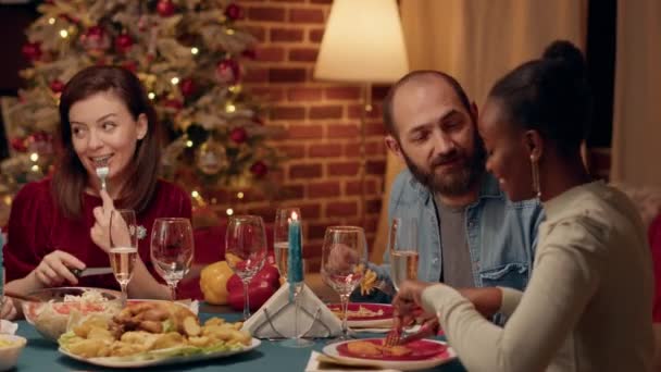 Friendly Young Adults Chatting Together While Enjoying Christmas Dinner Home — Vídeo de stock