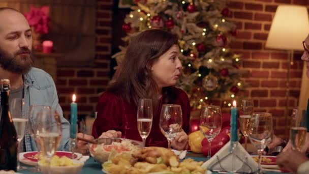 Festive Married Couple Enjoying Chatting Relatives While Sitting Christmas Dinner — Stockvideo
