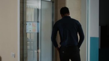Company employee leaving work but starting to run when disgusting brain-eating monsters come out of elevator. Person going home but bizarre evil looking zombies get in way and chase him.