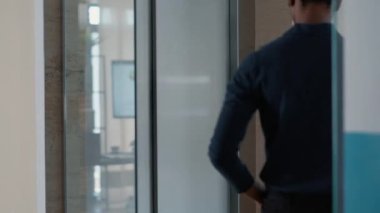 Agent leaving workplace when dangerous looking zombies coming out of elevator.Young adult person going home when doomsday bloody zombies chasing him downstairs inside building.