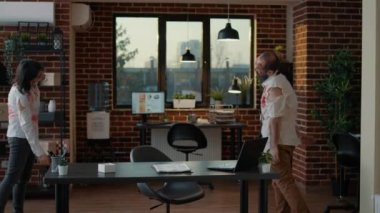 Mindless heavy wounded zombies wandering around office while searching for brains. Horror brain-eating monsters with bloody and deep scars roaming inside workspace while looking for victims.