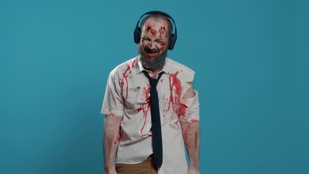 Messy Creepy Zombie Wearing Electronic Wireless Headphones While Listening Music — 图库视频影像