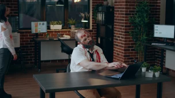Страшный Зомби Сидящий Офисе Работая Над Современным Ноутбуком Безмозглый Грязный — стоковое видео