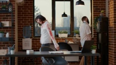 Creepy crippled office zombies wandering around workspace while picking document papers. Mindless dirty evil monsters in company space roaming around while moving documents from one place to another.