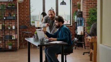 Timelapse of business people working on laptop in company office, doing collaboration with data report at accelerated speed. Colleagues doing teamwork partnership in quick motion.