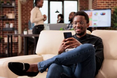 Company manager browsing internet on smartphone, using social media online website to create business report. Working on mobile phone to do research and plan corporate presentation, job network.