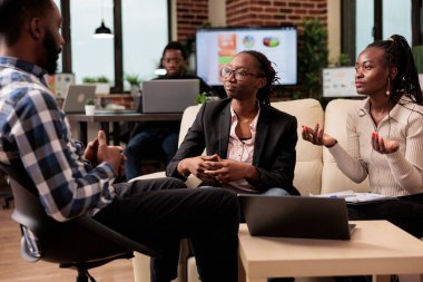 Business people brainstorming ideas at work, planning project presentation with documets and laptop. Coworkers working on research information to create report, corporate partnership collaboration.