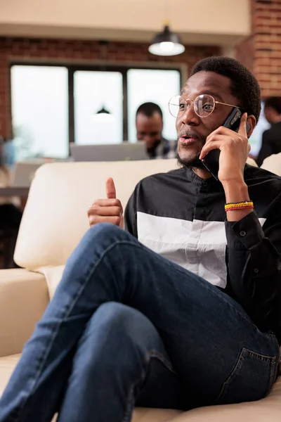 Corporate manager using smartphone call line to talk to people about office paperwork and online research data. Employee talking on mobile phone to work on startup presentation, sending emails.