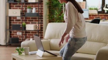 Hurried woman working remotely on laptop while developing startup project because of early deadline. Beautiful freelancer doing remote work on modern computer while developing business ideas at home.