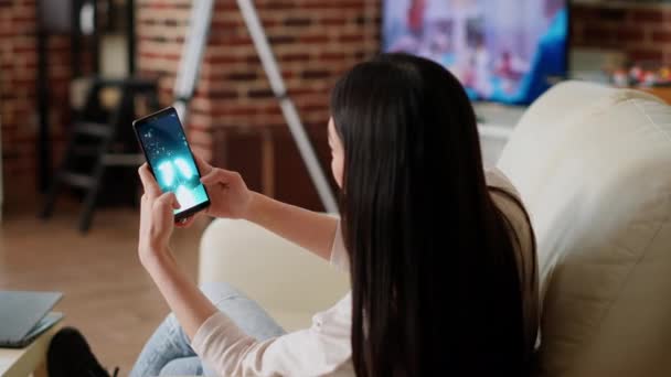 Childish Asian Person Enjoying Mobile Gaming While Sitting Sofa Modern — Stock video