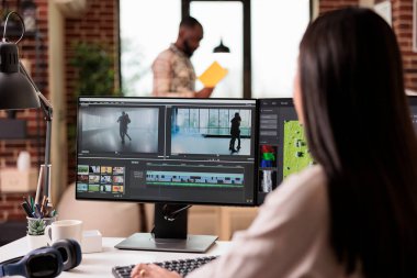 Professional editor using montage to edit film in multimedia software for post production. Editing movie footage with sound and creative effects, creating audio and visual content.
