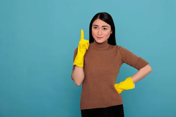 Smiling Satisfied Delighted Asian Houseworker Wearing Yellow Gloves Pointing Finger — Stok fotoğraf