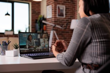 Female freelancer meeting on remote videoconference with people on laptop webcam, chatting on virtual videocall conference. Talking on online teleconference chat, web discussion.