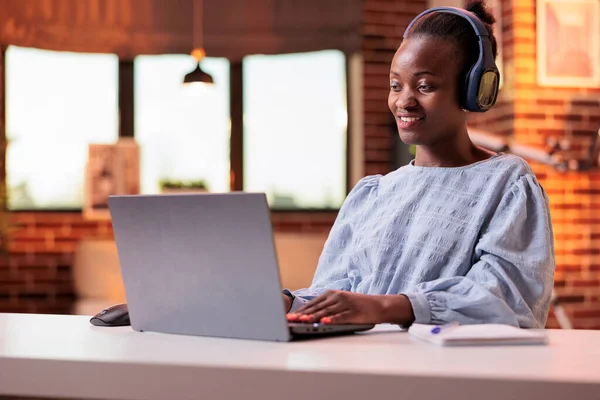 Smiling Student Headphones Attending Online Classes Laptop Home African American — стоковое фото