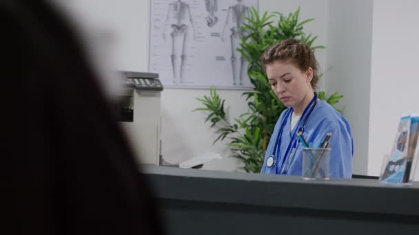 Portrait Medical Assistant Working Hospital Reception Desk Using Computer Healthcare — Vídeos de Stock