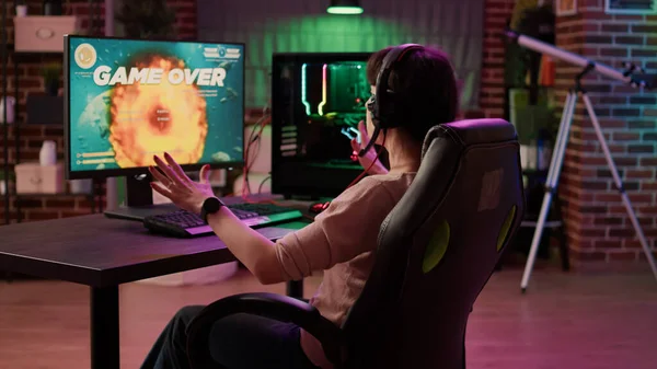 Man gamer teaching his girlfriend playing space shooter video game Stock  Photo by ©DragosCondreaW 465086788