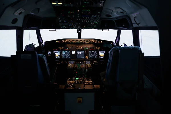 No people in empty captain cabin used to fly airplane with dashboard command and control panel navigation. Throttling engine lever and flying jet with buttons, power switch and handle.