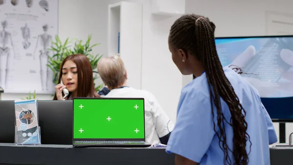 African American Nurse Using Laptop Greenscreen Display Hospital Reception Desk — Photo