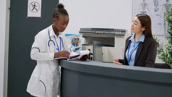 Portrait African American Doctor Analyzing Medical Report Papers Receptionist Hospital — Stock Photo, Image