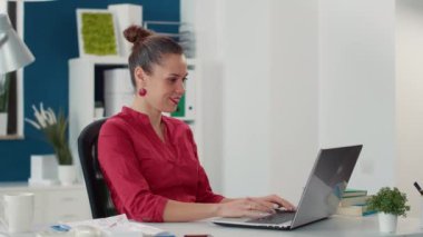 Financial analyst with marketing expertise working on laptop, planning research strategy with sales statistics charts. Female company employee analyzing executive project plan.