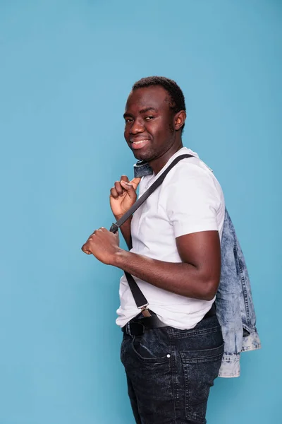Fashion African Ethnicity Man Holding Denim Jacket Back While Smiling — Stock Photo, Image