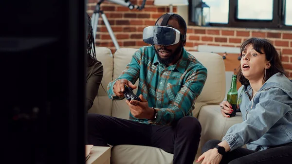 Friends playing video games with vr glasses and losing challenge on television console, using virtual reality headset to lose gaming competition. Feeling sad about lost gameplay.