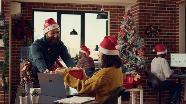 Office Employees Exchanging Presents Work Feeling Festive Santa Hats Office — Stock Photo, Image