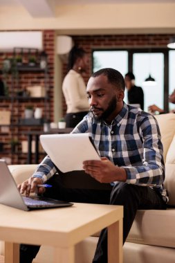 Afrika kökenli Amerikalı serbest çalışan şirket ofisinde evrak işleri planlıyor. Başlangıç raporunu oluşturmak için Documets ve laptop verilerini analiz ediyor. Şirket sunumunu planlamak için araştırma bilgileriyle çalışmak.