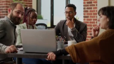 Business people doing teamwork partnership to create startup presentation, analyzing charts data information to do online research. Working with graphs statistics, coworkers meeting in boardroom.