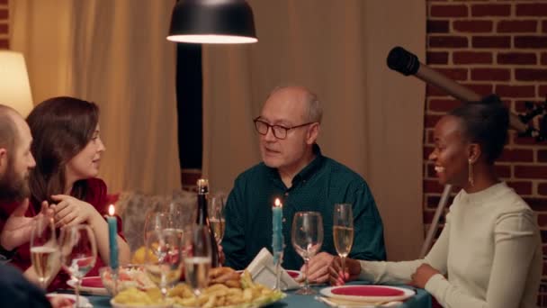 Cheerful Senior Man Talking Young Woman While Christmas Dinner Table — Vídeo de Stock