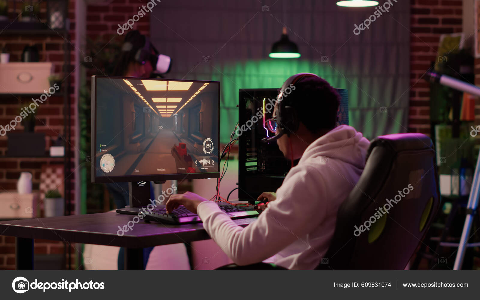 Man playing multiplayer online action game while gaming girl is fighting in  virtual reality game at home. Gamer streaming first person shooter on pc  while girlfriend uses vr goggles for simulation Stock