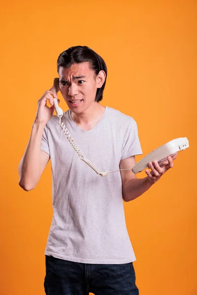 Young Angry Man Talking Landline Phone Irritated Asian Teenager Shouting — Stock Photo, Image