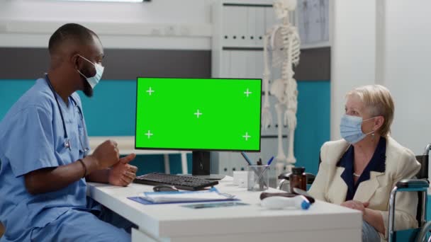 Nurse Looking Greenscreen Display Paralyzed Patient Wheelchair Checkup Visit Assistant — Stock video