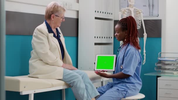 Assistant Holding Digital Tablet Greenscreen Template Consultation Elderly Patient Woman — Stock video