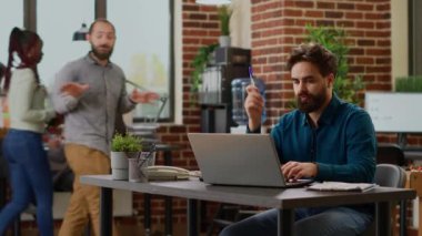 Thoughtful businessman brainstorming ideas to create report on laptop, feeling pensive and thinking about good decision to create presentation. Stressed worker pondering company solution.